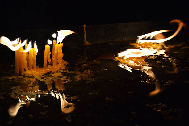 istock Burning candles in a church on a dark background 510633475