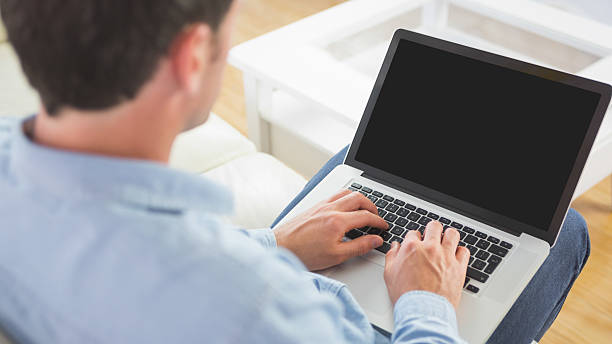 istock Looking over shoulder of casual man using laptop 510635083