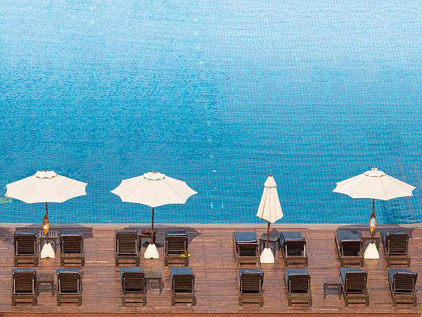 istock Beach chairs and umbrella side swimming pool 510635489