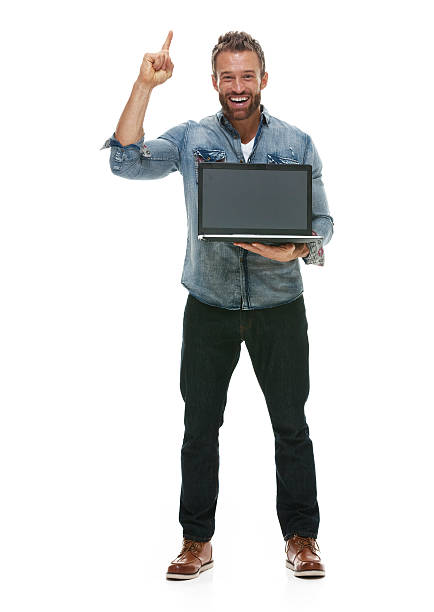 istock Cheerful casual man holding laptop and pointing 510635998