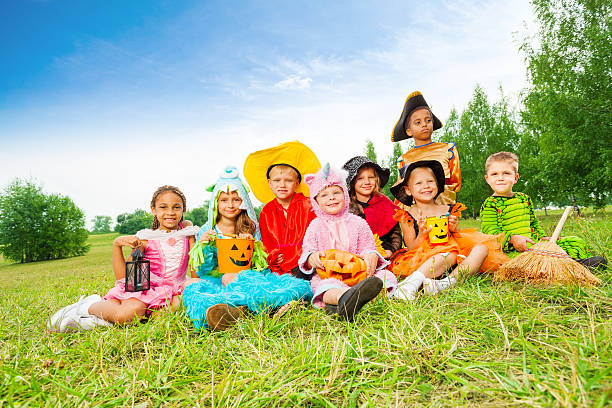 istock Children in Halloween costumes sit together 510636349