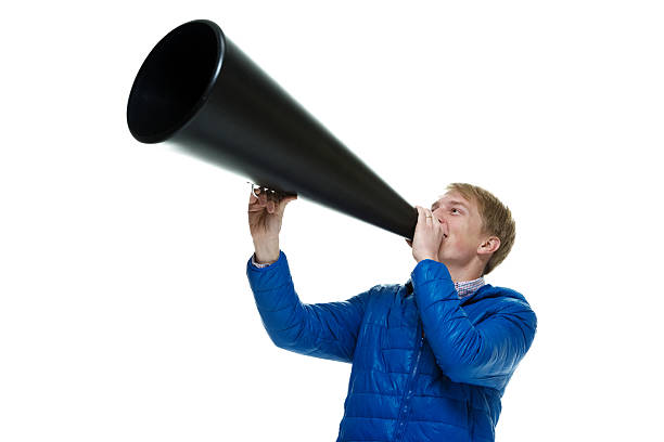 istock Smiling casual man shouting with megaphone 510641172
