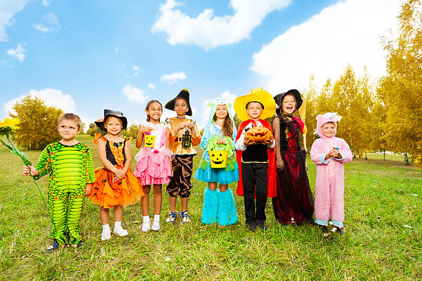 istock Kids with Halloween costumes stand in row 510655901