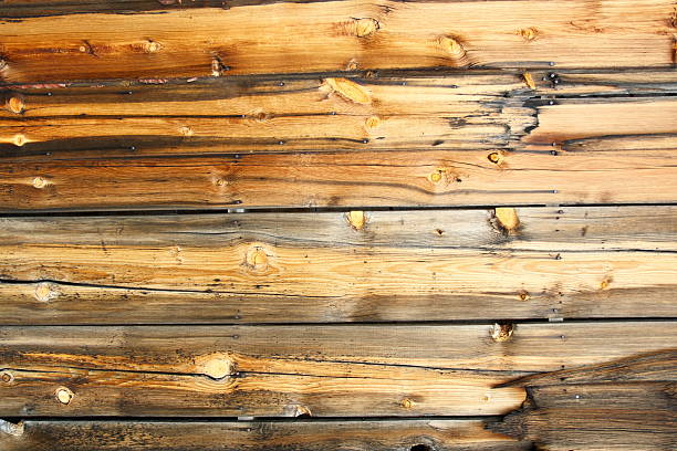 Pine wood wall dark brown background. Pine boards building paneling. Natural wood background.