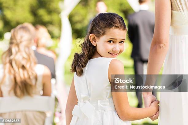 Flower Girl Holding Brides Hand During Outdoor Wedding Stock Photo - Download Image Now