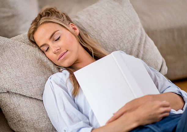 istock Woman falling asleep reading 510660097