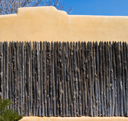 Wooden Coyote Fence, Against Stucco Wall in Southwest USA