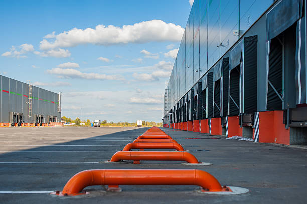 istock Cargo doors at big industrial warehouse building 510676504