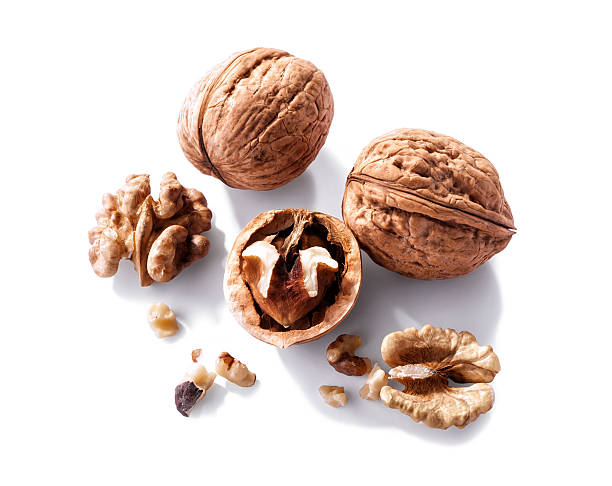 nueces close-up aislado sobre fondo blanco - walnut pod nutshell cross section fotografías e imágenes de stock
