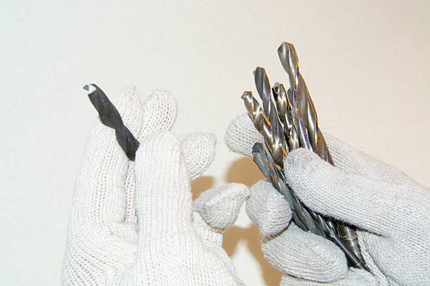 istock hand in white gloves hold a set of drill bits 510680996