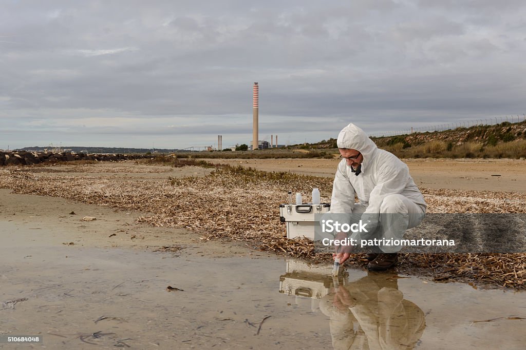 Expert Analyze the Water Experts analyze the water in a contaminated environment. Scientific Experiment Stock Photo