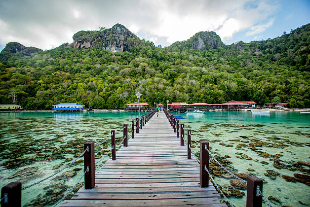 Jetty toward Bohey Dulang Island Jetty toward Bohey Dulang Island in a clear sunny day. island of borneo stock pictures, royalty-free photos & images