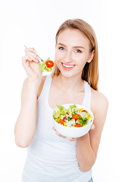 istock Smiling woman eating salad 510686248