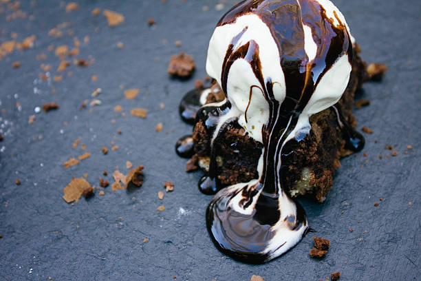 Brownie with vanilla ice cream and chocolate syrup Brownie with vanilla ice cream and chocolate syrup fudge stock pictures, royalty-free photos & images