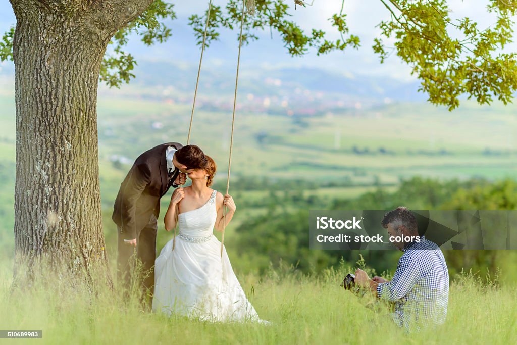after wedding photo shoot videograph and grooms kissing in nature. Wedding Stock Photo