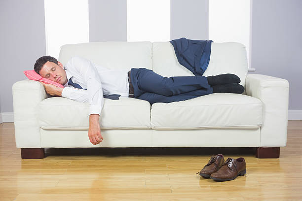 istock Calm handsome businessman sleeping on couch 510690251