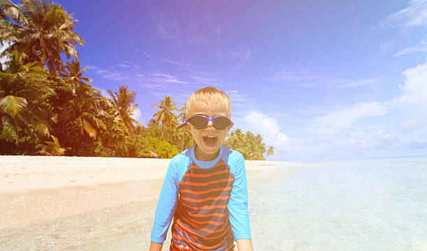 istock happy boy in swimming goggles on beach 510690676