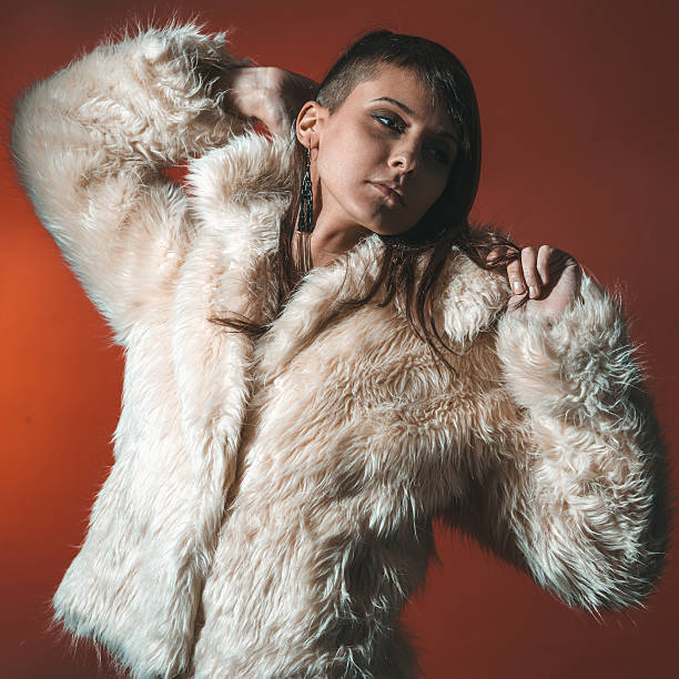 istock Young brunette lady in white fur coat 510691020