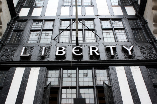 London, England - Sept 4th, 2014: The sign above the entrance to the Liberty department store in central London. Opened in 1875 the store is identified with luxury goods and classic designs.