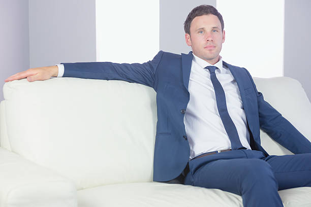 istock Content handsome businessman relaxing on couch 510691857