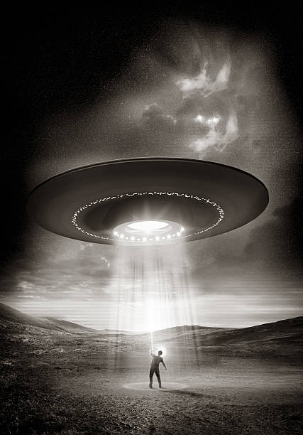 Out There Out There. A man shields his eyes from the bright UFO above him. Abduction probable! crop circle stock pictures, royalty-free photos & images
