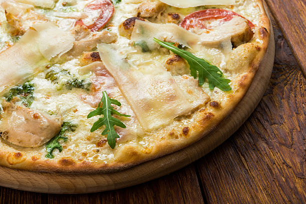 istock Delicious pizza with chicken, parmesan and fresh arugula 510694530