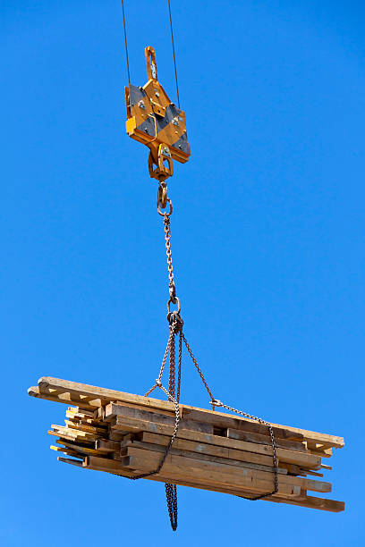 istock Crane is lifting wooden planks 510694563