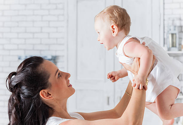 istock Mother playing with daughter, holding her up 510694833