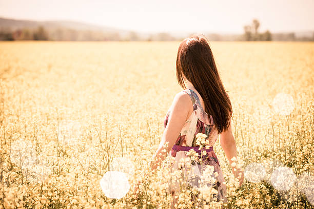 istock Young woman in rapeseed field 510695632