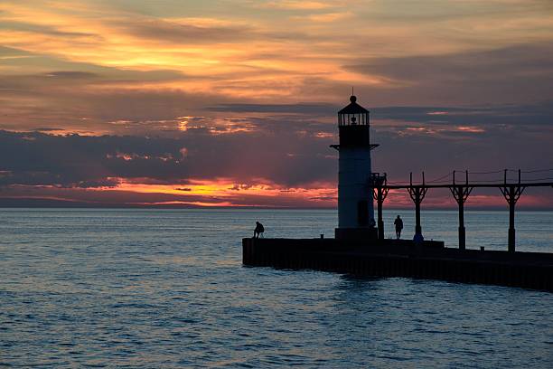 istock Fishermen by the light house at dusk 510696281