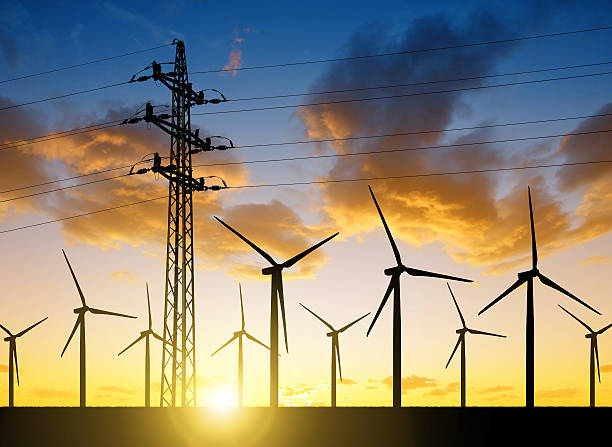 istock High voltage tower and wind turbines 510697130