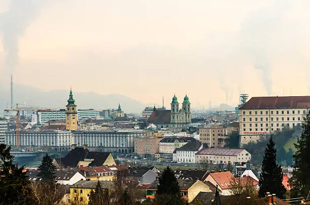 Skyline of Linz on a cloudy and misty february morning. Linz is the capital city of Upper Austria and has more than 200.000 citizens. Soft post-processing with professional photo editing software. Photo made outdoor with a D7000 and 16-85mm lens. Low ISO, soft grain.