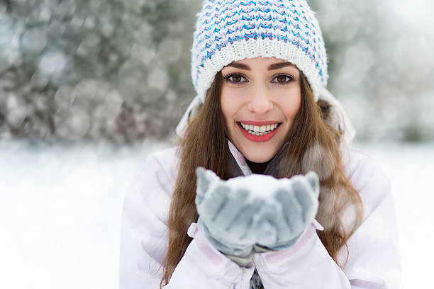 istock Smiling woman holding snow 510699382