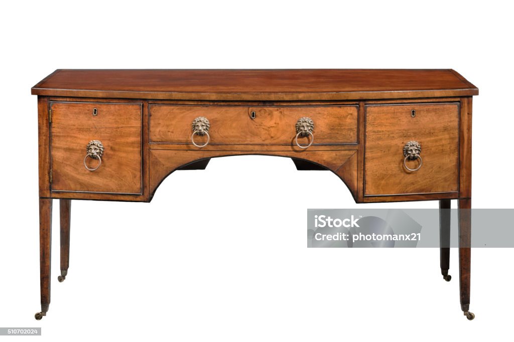 Sideboard cupboard bow fronted mahogany antique with lion handle Antique bow fronted mahogany sideboard with brass lion handlesisolated on white with clipping path Furniture Stock Photo