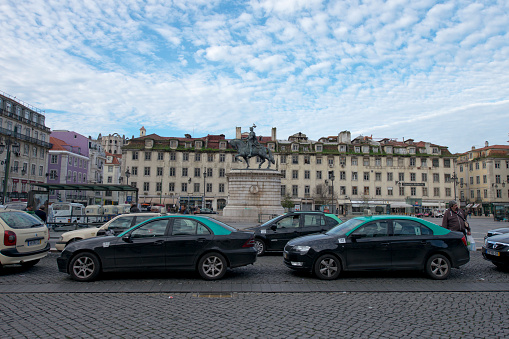Lisbon, Portugal - January 23, 2016: Taxis waiting in Figueira Square on January 23, 2016 in Lisbon, Portugal.