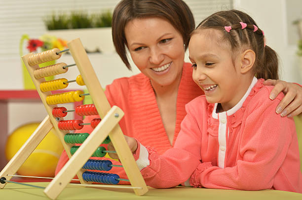 istock girl doing math exercises with  mother 510703454