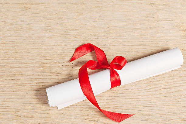 istock Scroll of paper with a red ribbon. 510720049