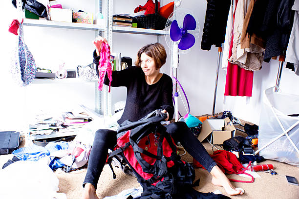 istock woman is packing backpack in a messy room 510720429