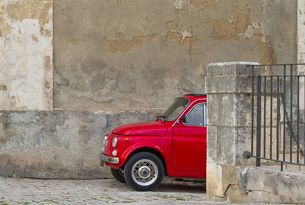 istock Cute Red Vintage Car And Old Textured Wall, Sicily 510721017