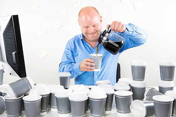 istock Smiling businessman drinks too much coffee 510721031