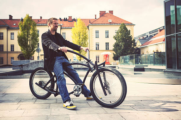 istock Smiling mid adult man on the custom made bicycle 510722703