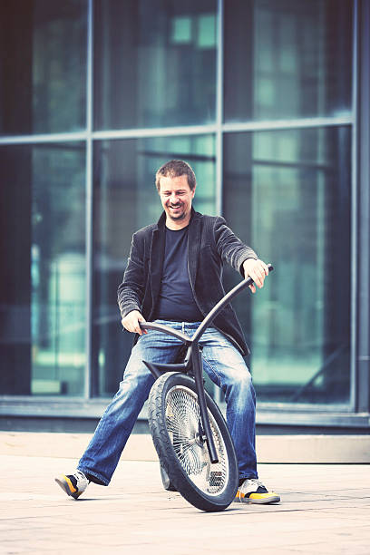 istock Smiling mid adult man on the custom made bicycle 510724329