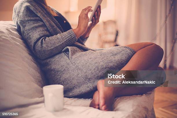 Young Woman Using A Tablet At Home Stock Photo - Download Image Now - Adult, Adults Only, Beautiful People