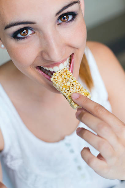 istock Woman eating muesli bar snack. 510725517