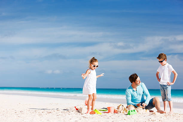 istock Father with kids at beach 510725847