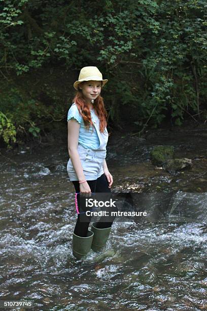 Image Of Girl Playing Paddling Wading In River Woodland Stream Stock Photo - Download Image Now