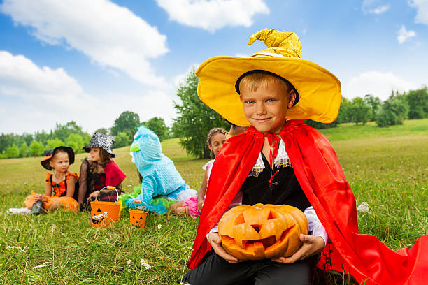 istock Boy in wizard costume holds Halloween pumpkin 510739787