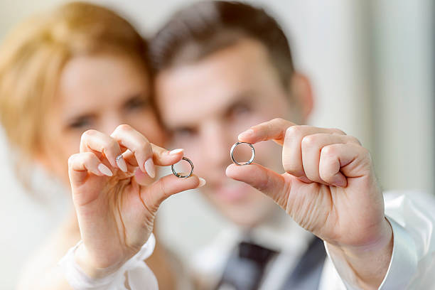new weds golding hands showing wedding rings