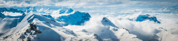 istock White winter mountains snowy peaks panorama above the clouds Alps 510740919