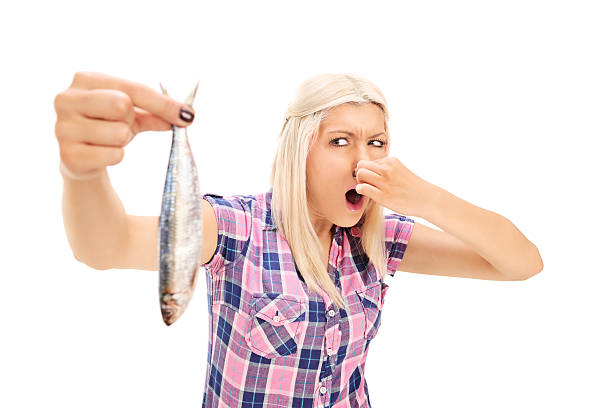 istock Blond woman holding a stinky fish 510741301